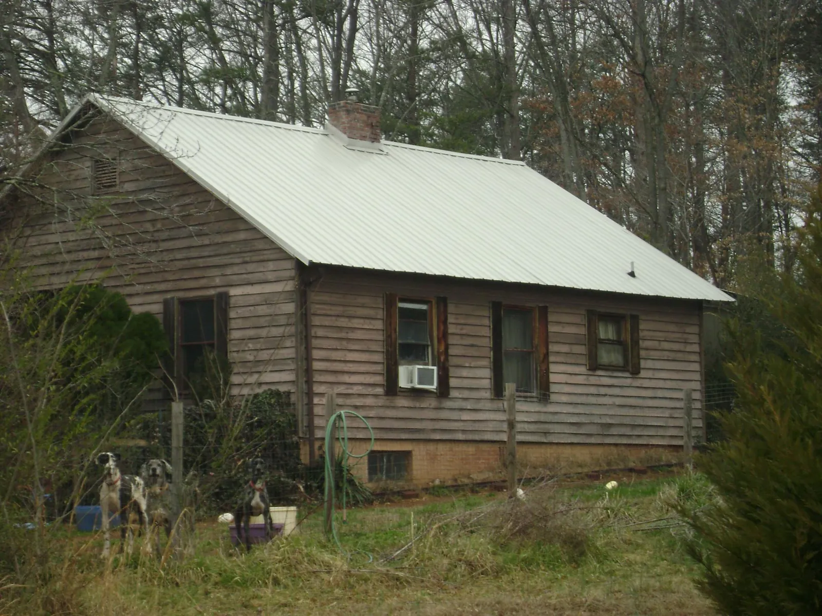 White metal roof on an old wood sided farmhouse, from a Metal Roof Installation job in Cheswick